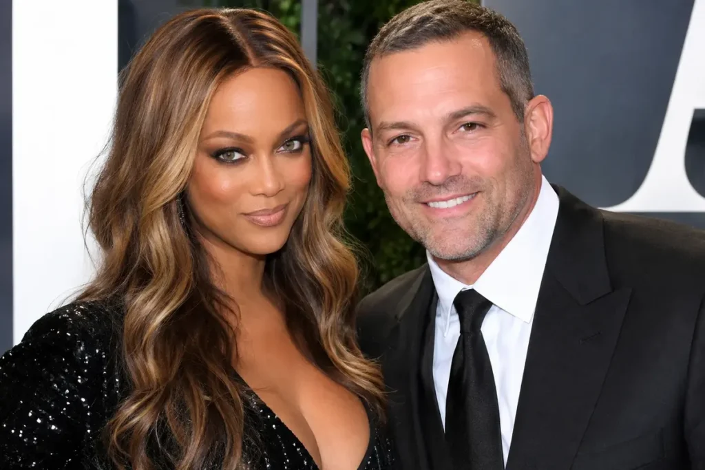 Tyra Banks and Greg Hayes posing together at a red carpet event